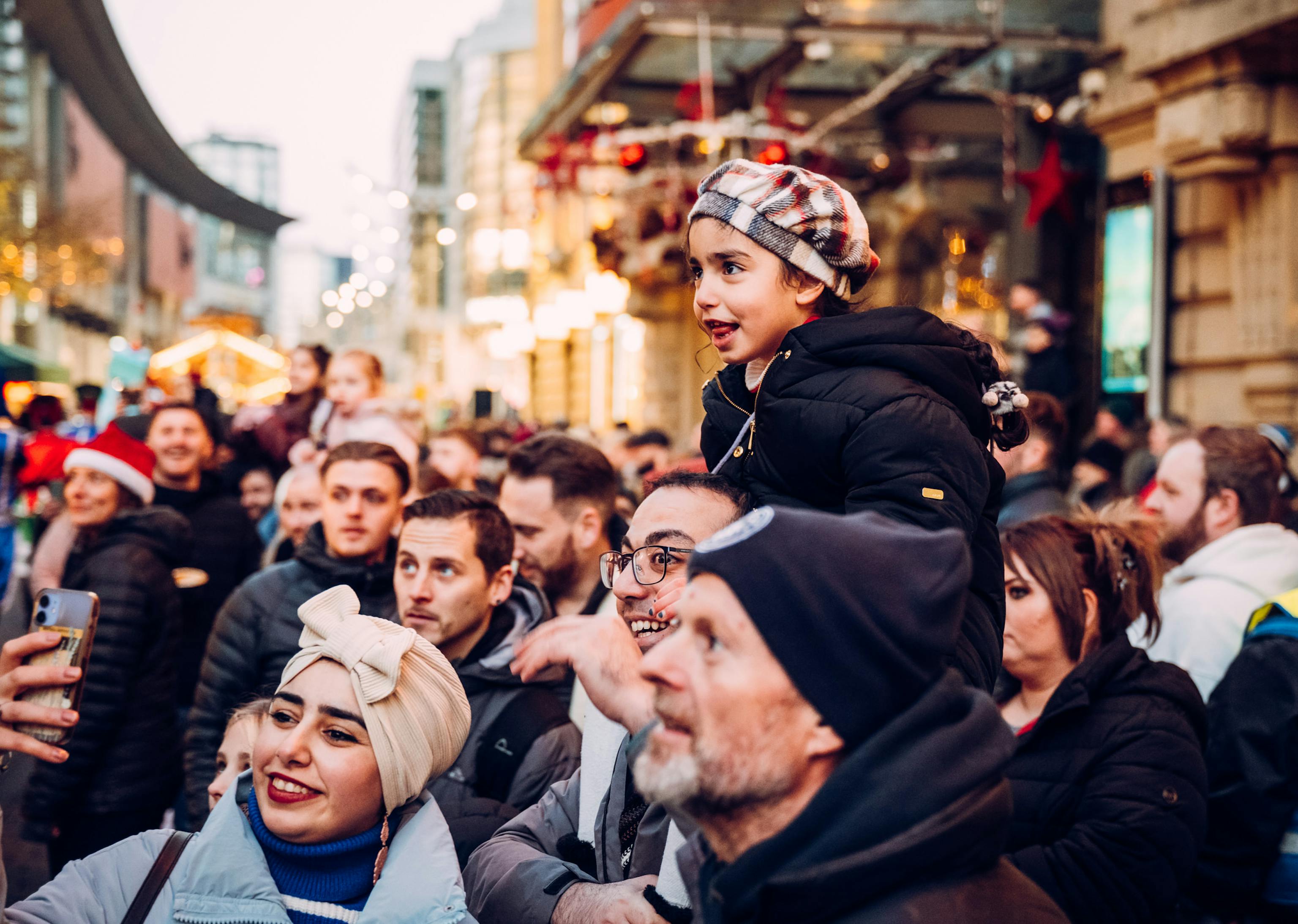 A crowd of people smiling at a performance