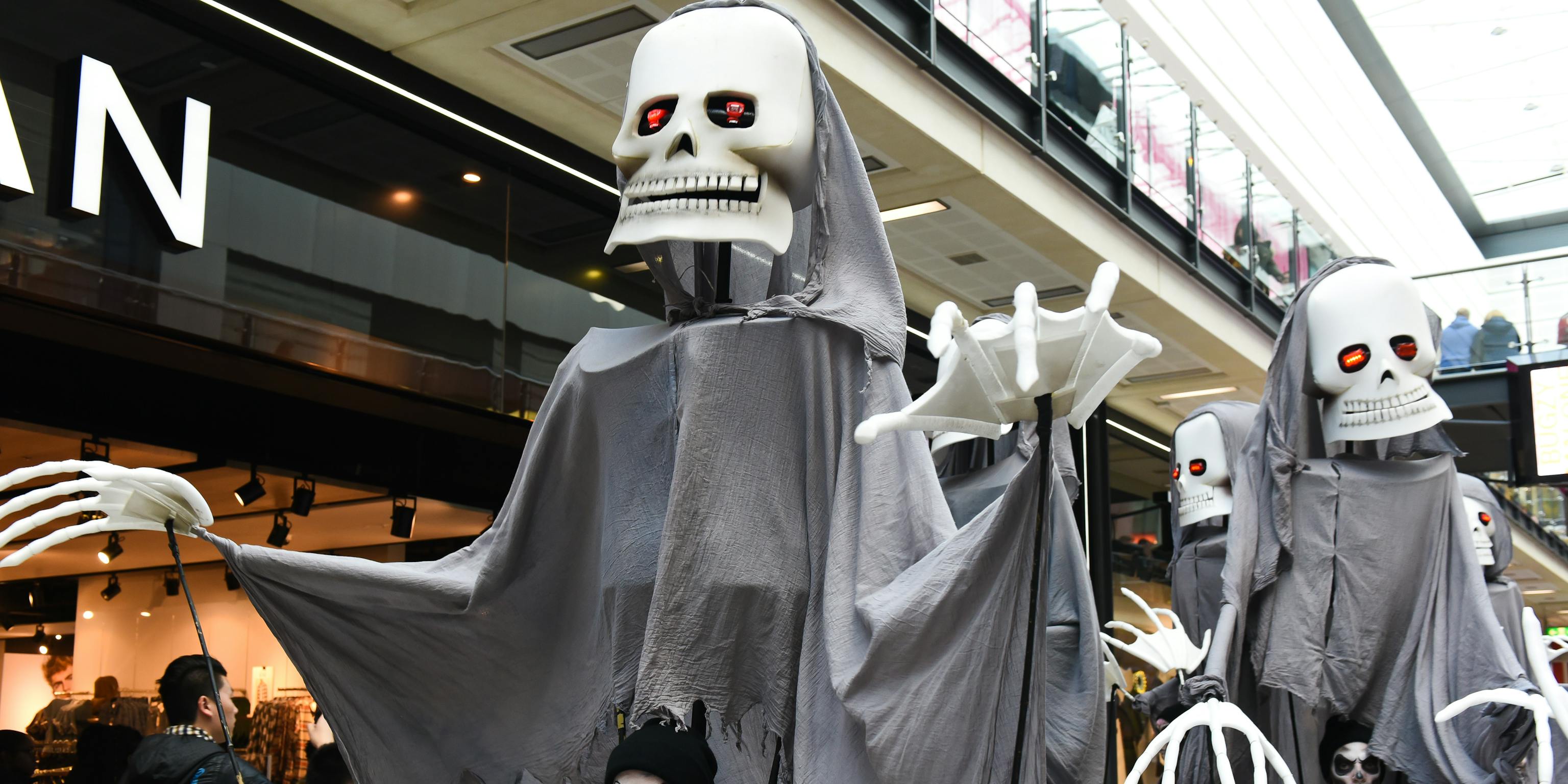 A procession of large skeleton puppets