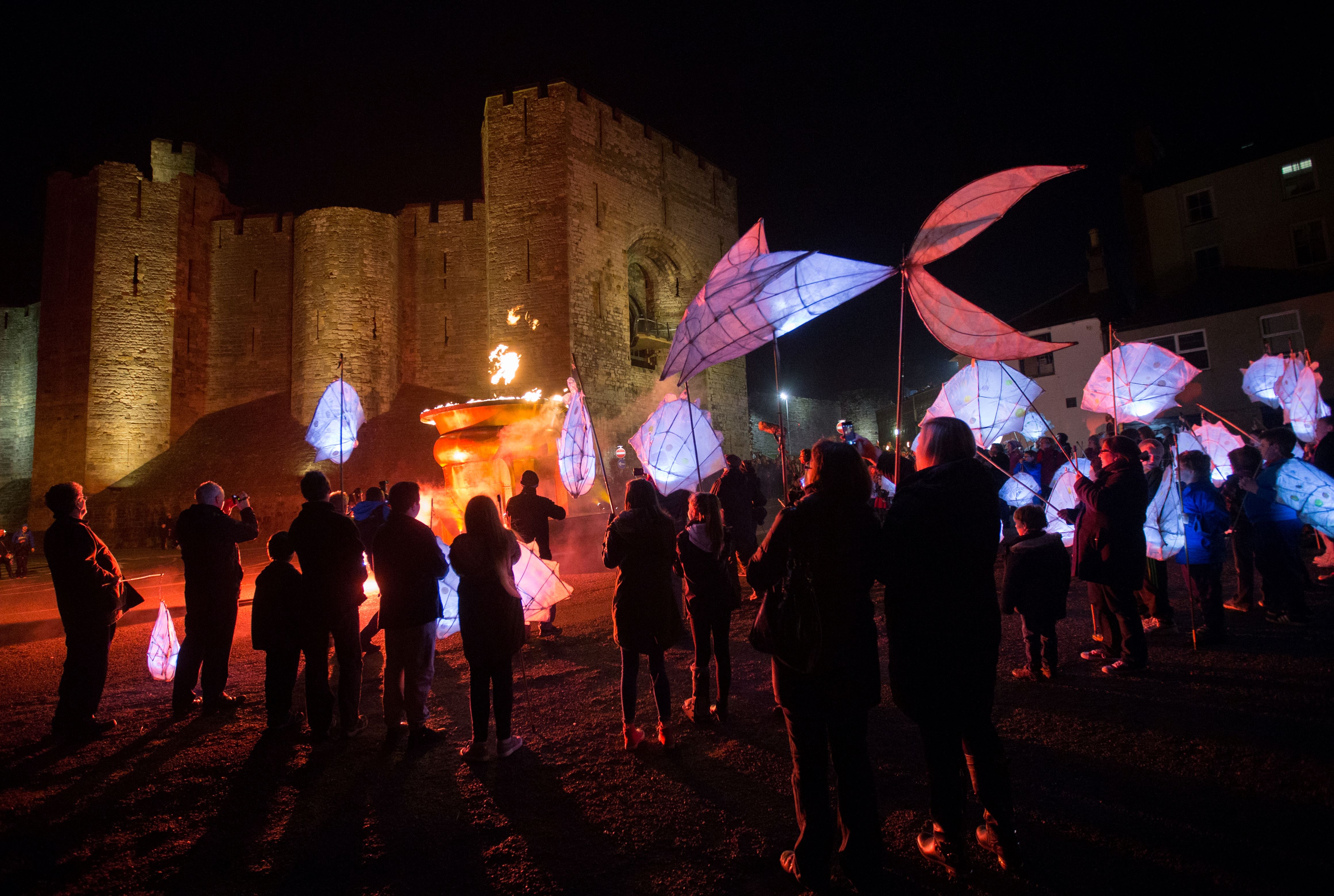 A lantern procession heading towards a castle