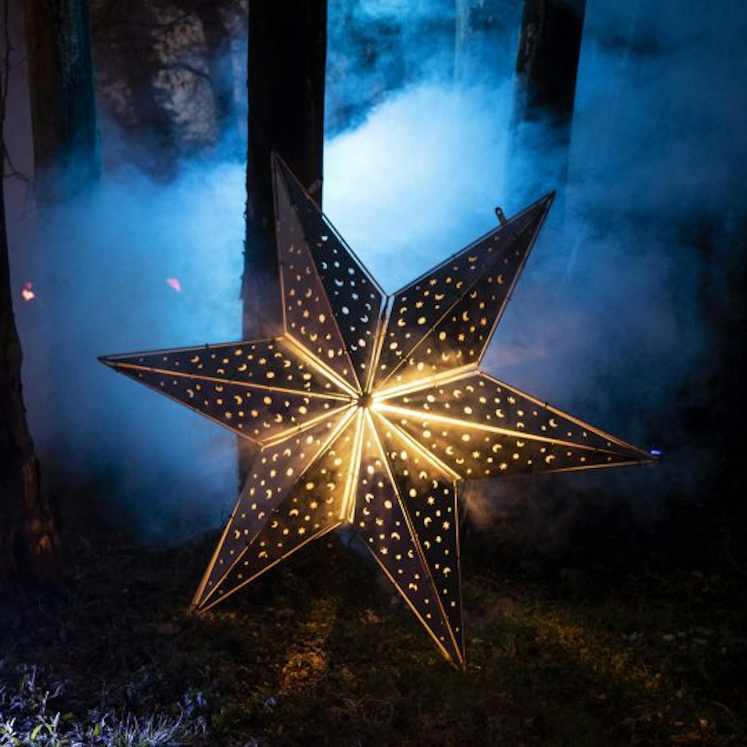 Illuminated star on misty backdrop