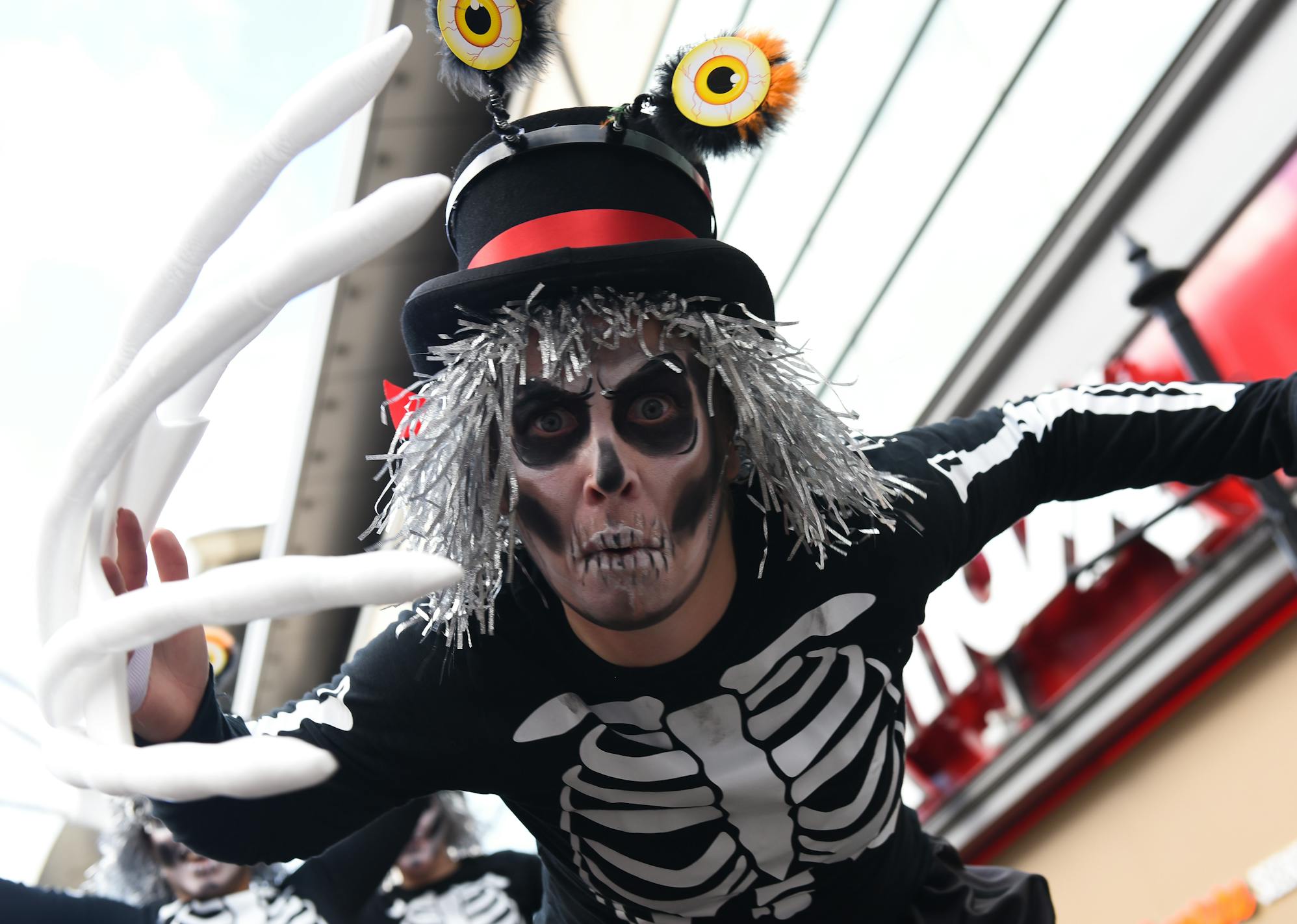 A performer in skeleton make-up leaning towards the camera
