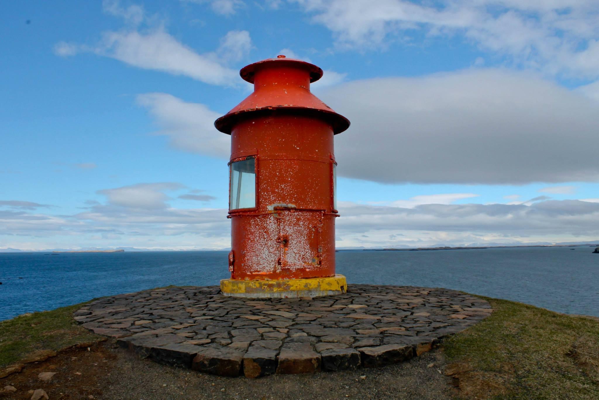 Red lighthouse overlooking the ocean