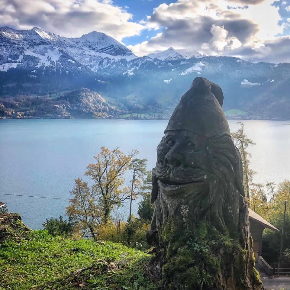 Sculupture of a gnome with the lake in the background