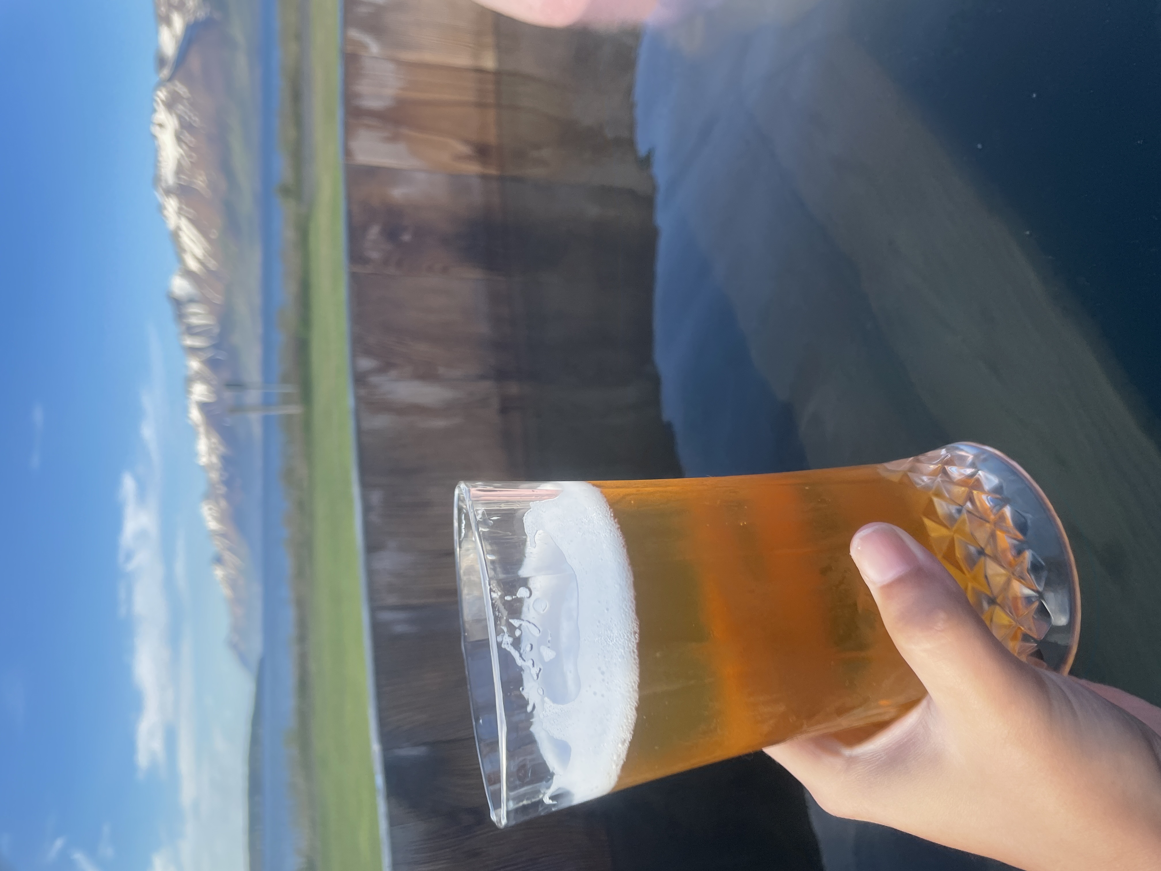 Beer in a beer filled hot tub with mountains in the distance