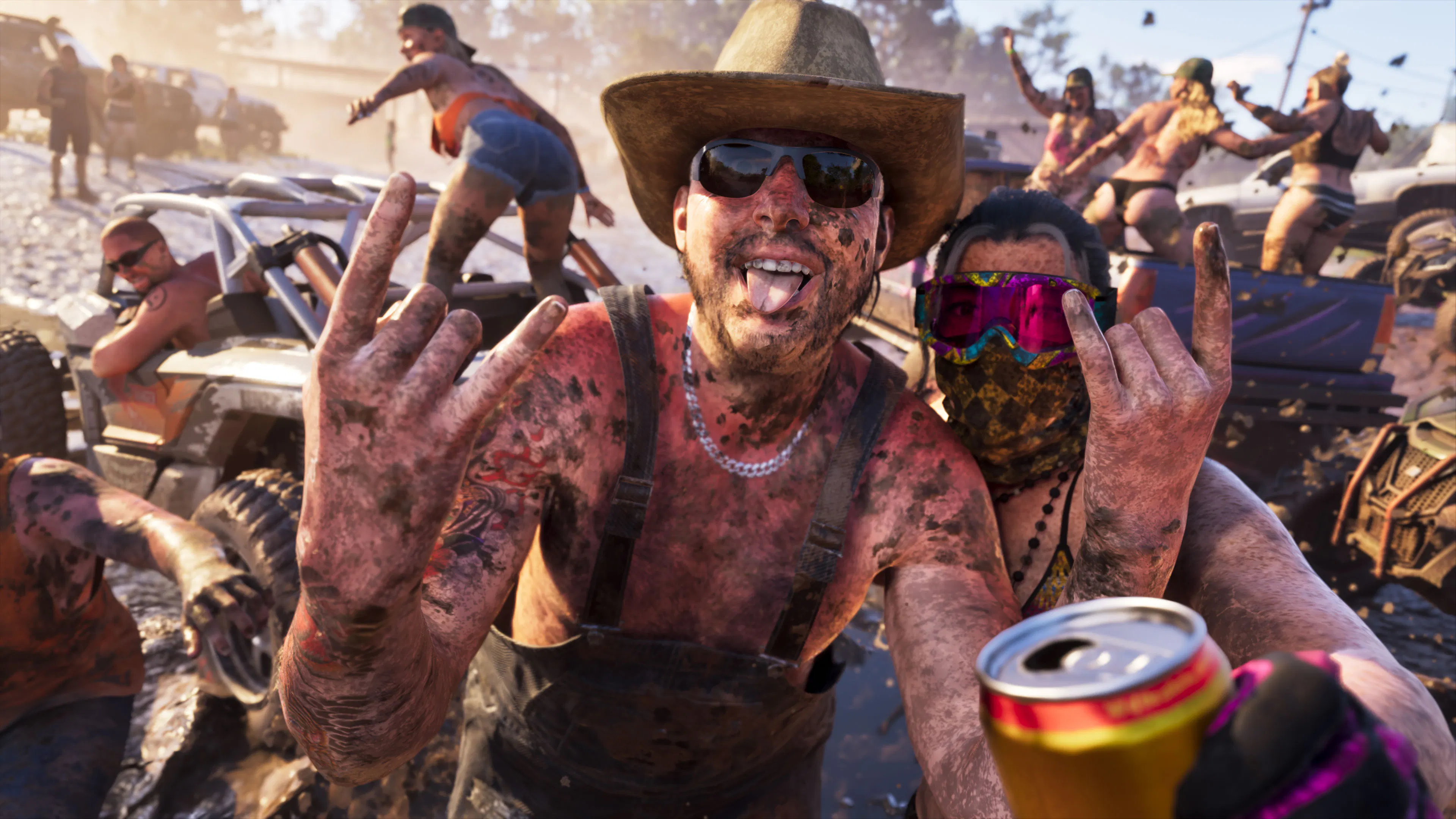 A mud-covered party around off-road vehicles, beer cans raised.