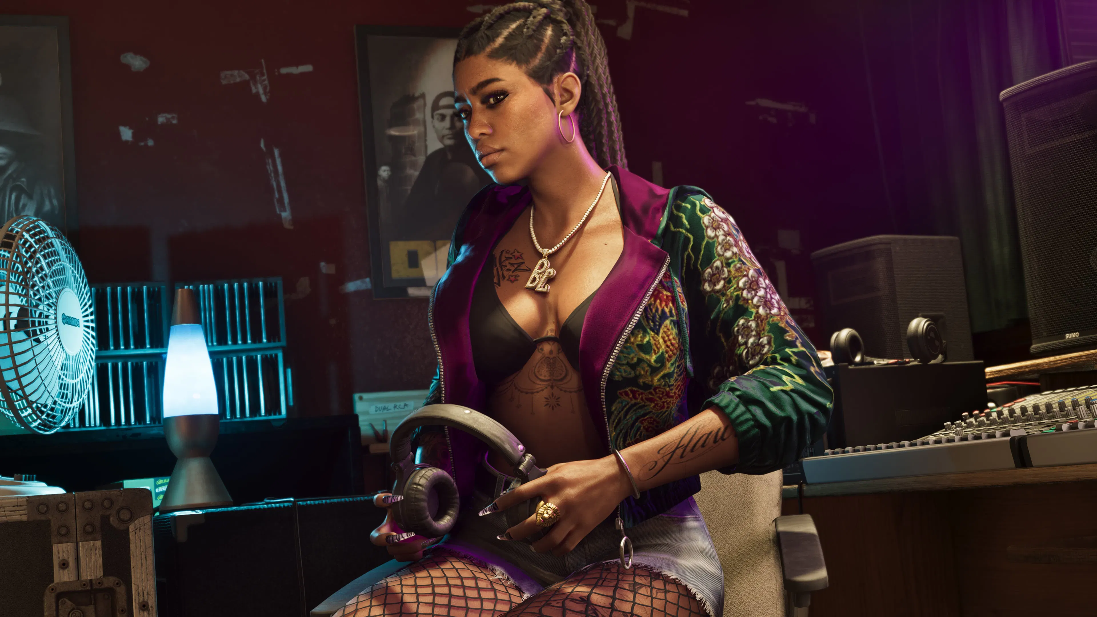A member of Real Dimez in a recording studio, headphones in hand.