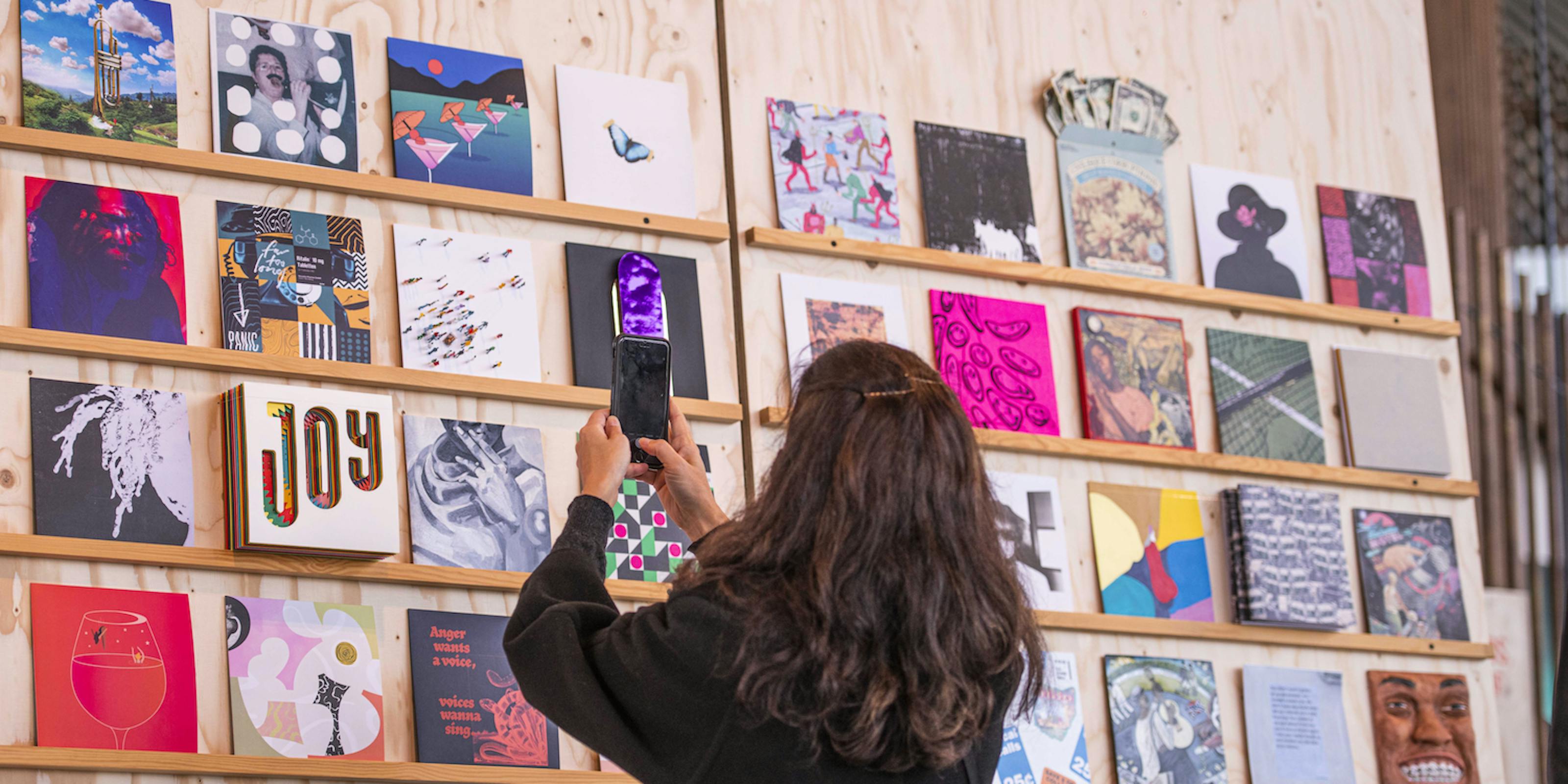A woman taking an image of the artwork in 2020.