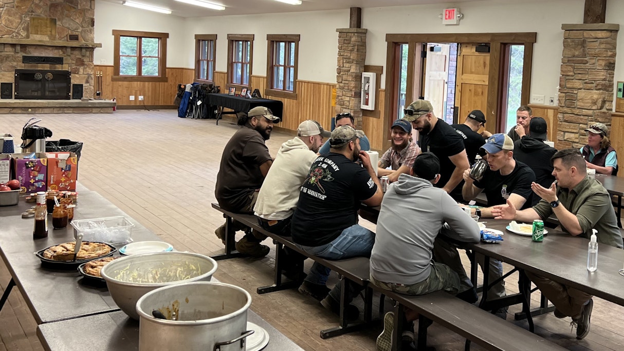 Inside the dining facility at Camp Rotary, Montana, soldiers from Creek Co 2-4 gather around the dining tables for a home cooked dinner prepared by volunteers from the Great Falls, Montana area.
