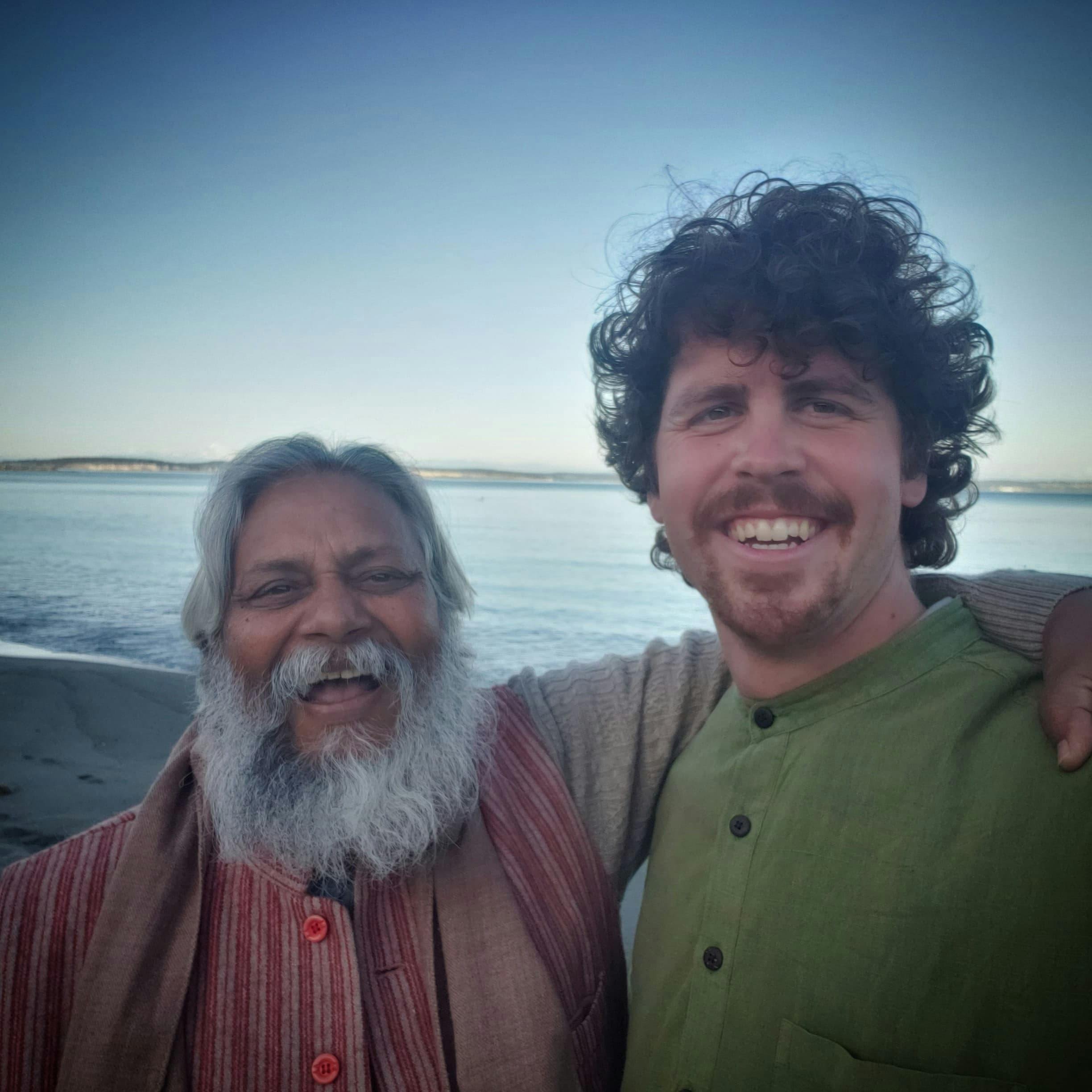 Zach Weiss and Rajendra Singh facing the camera and smiling, with arms around each other
