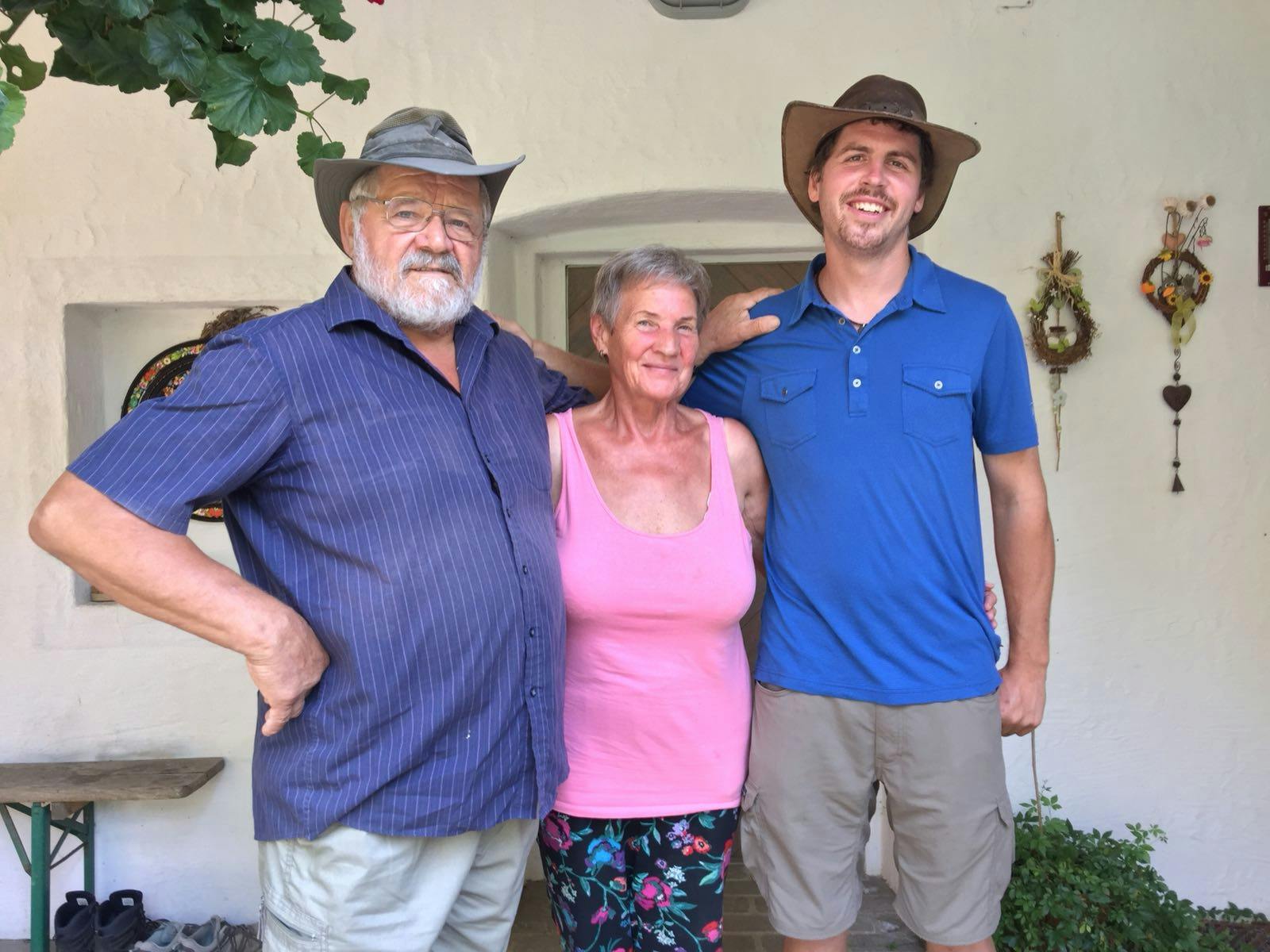 Sepp Holzer with his wife and Zach Weiss on the porch of the house at the Krameterhof farm