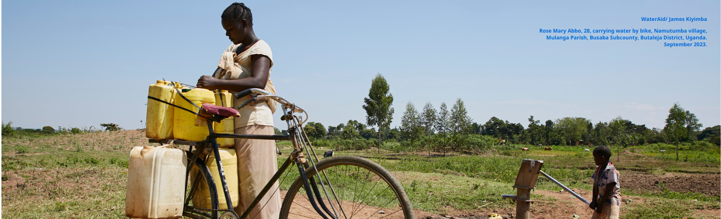 Rose collecting water by bike, carrying a baby on her back at Namutumba village.
