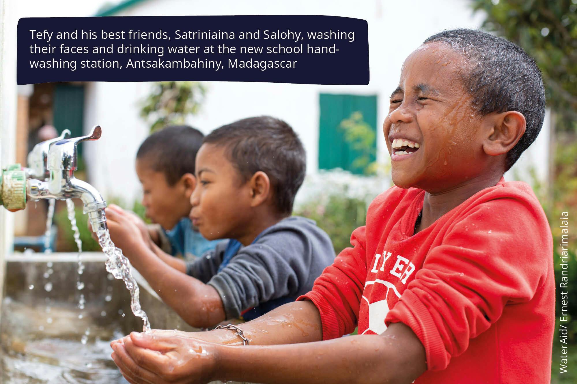 Tefy and his best friends, Satriniaina and Salohy, washing their faces and drinking water at the new school handwashing station, Antsakambahiny, Madagascar