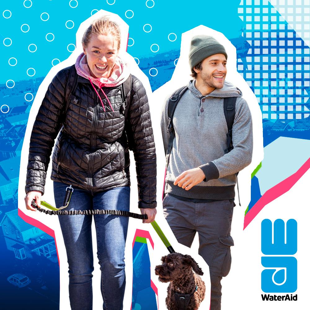 Two people walking a dog