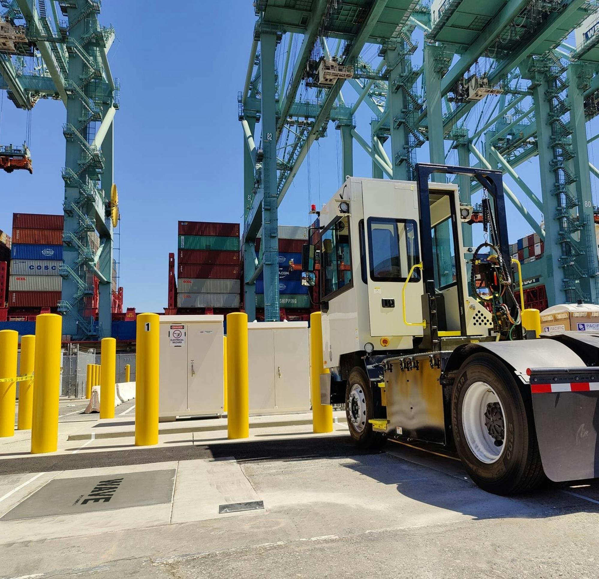 Yard tractor at port charging on a wireless charging pad Yard tractor at port charging on a wireless charging pad