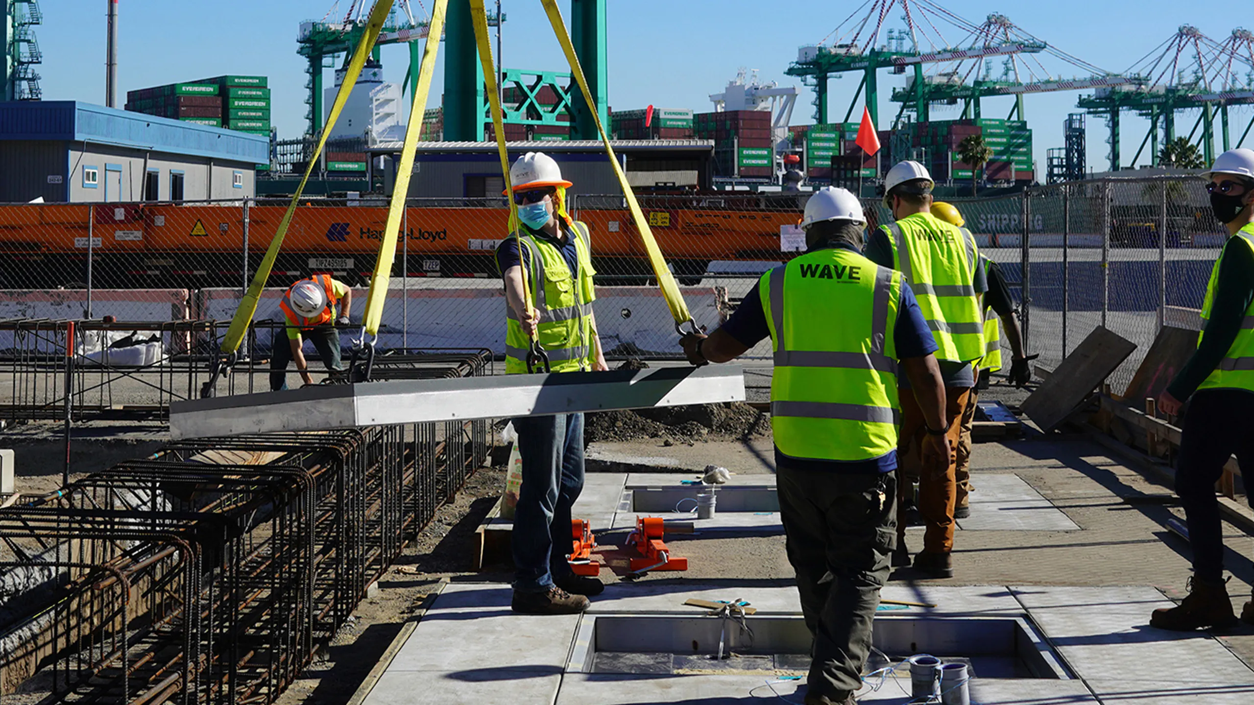 Construction workers installing a WAVE wireless charging pad Construction workers installing a WAVE wireless charging pad