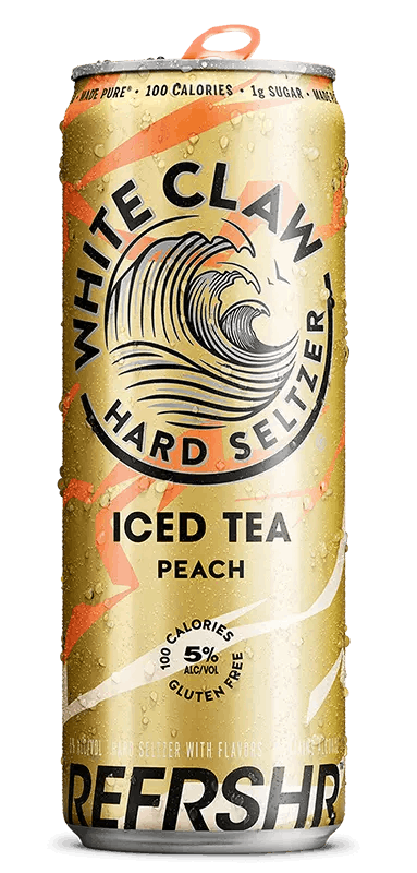 A can of White Claw® REFRSHR™ Iced Tea Peach sits on rocks in front of the sea.