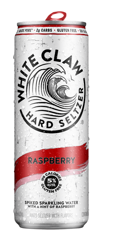 A can of White Claw® Hard Seltzer Raspberry sits on rocks in front of the sea.