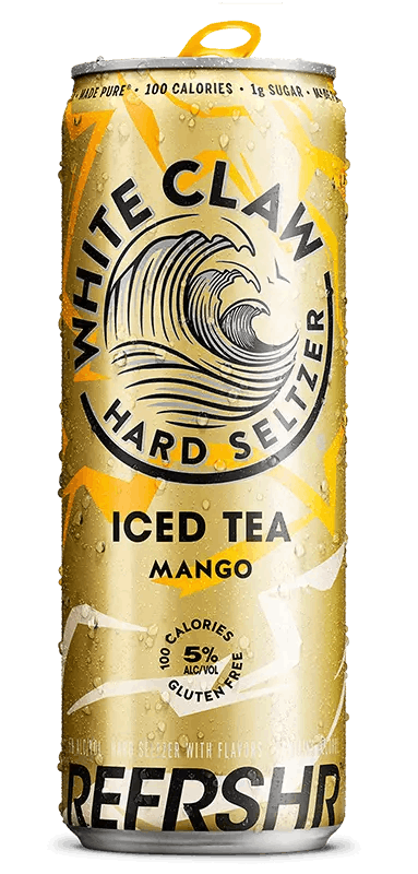 A can of White Claw® REFRSHR™ Iced Tea Mango sits on rocks in front of the sea.