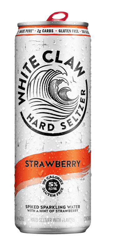 A can of White Claw® Hard Seltzer Strawberry sits on rocks in front of the sea.