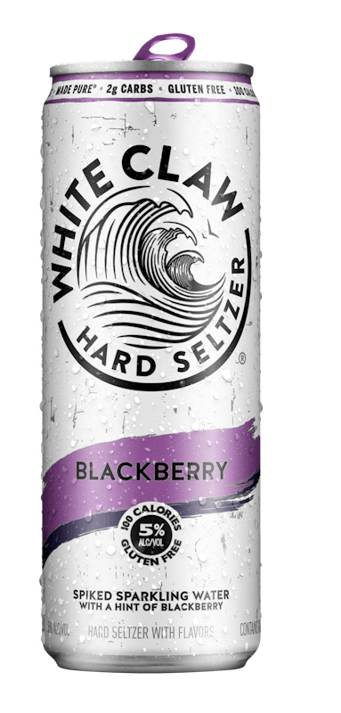 A can of White Claw® Hard Seltzer Blackberry sits on rocks in front of the sea.	