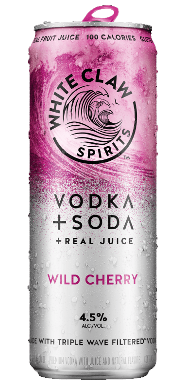 A can of White Claw™ Vodka + Soda Wild Cherry sits on rocks in front of the sea.