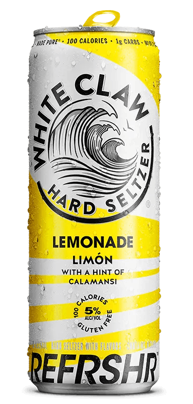 A can of White Claw® REFRSHR™ Lemonade Limón sits on rocks in front of the sea.