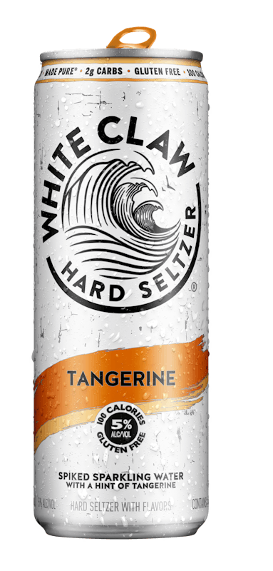 A can of White Claw® Hard Seltzer Tangerine sits on rocks in front of the sea.