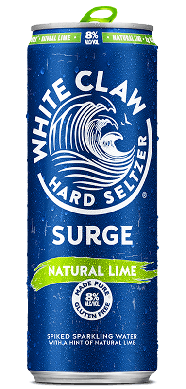 A can of White Claw® Surge Natural Lime sits on rocks in front of the sea.	