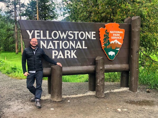 Jon in front of Yellowstone sign