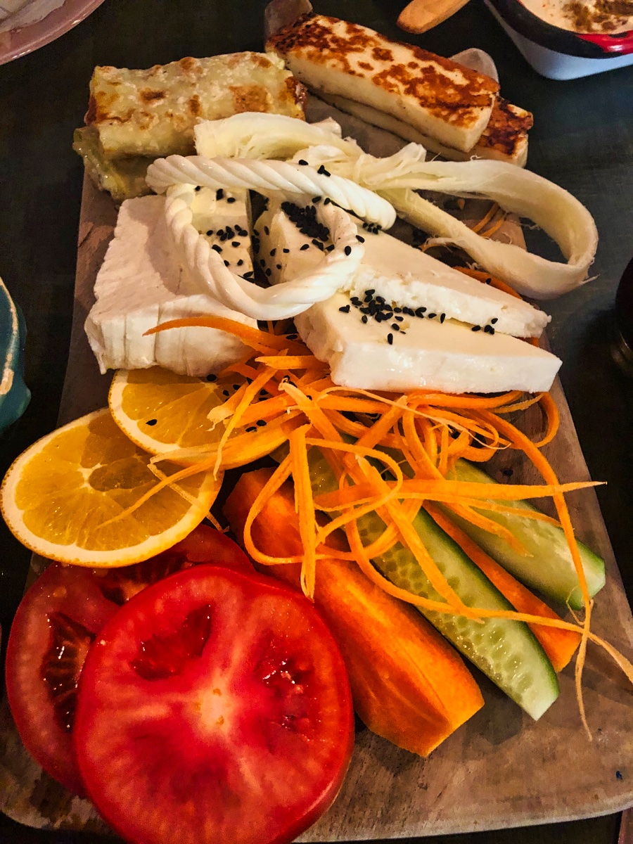 a close up of one platter of veg and cheese