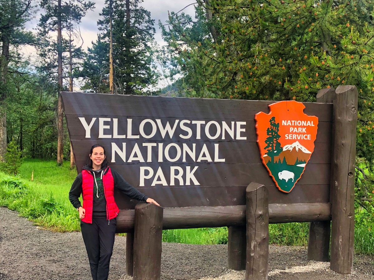Laura in front of Yellowstone sign