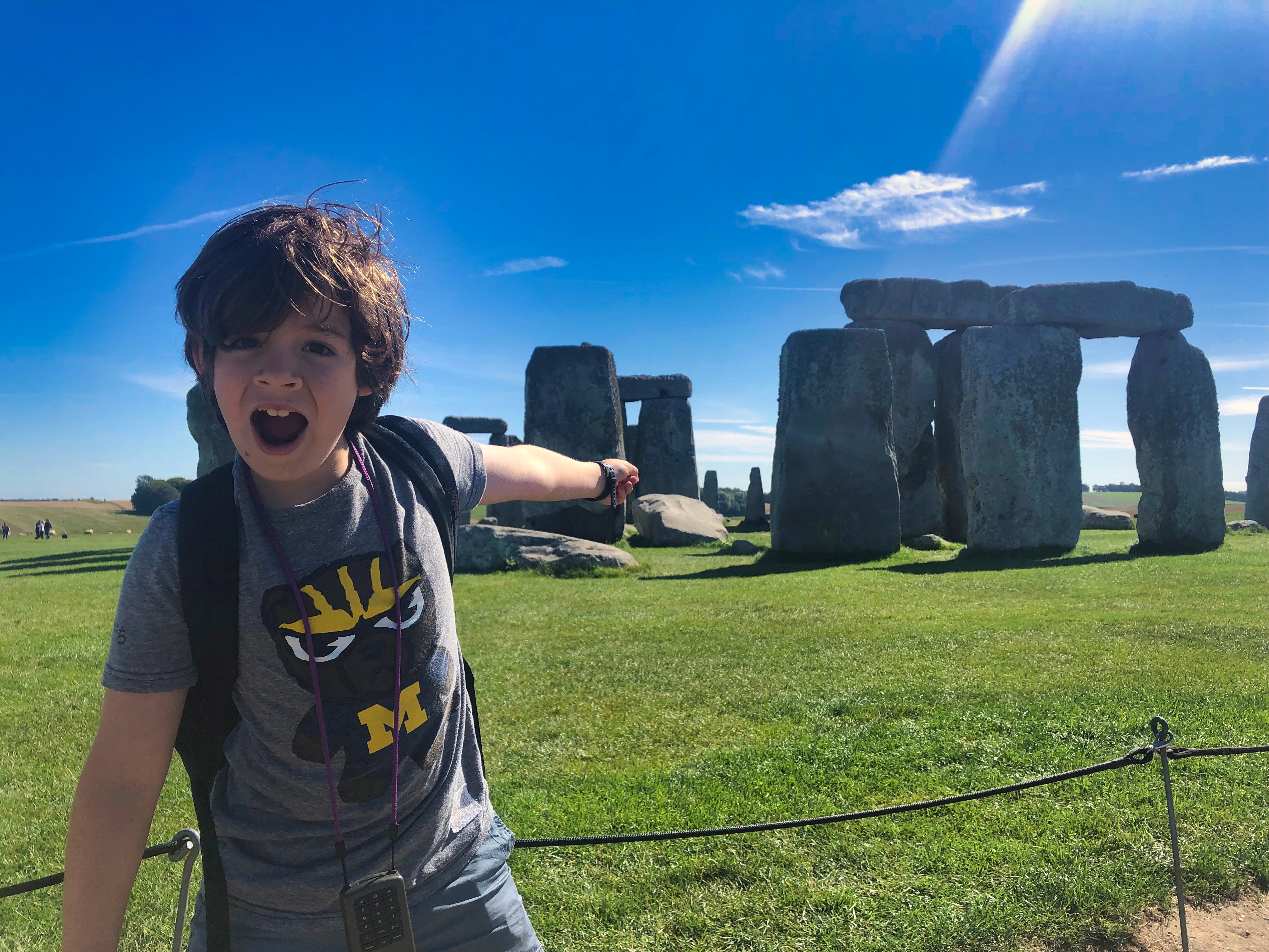 H pretty shocked by Stonehenge behind him