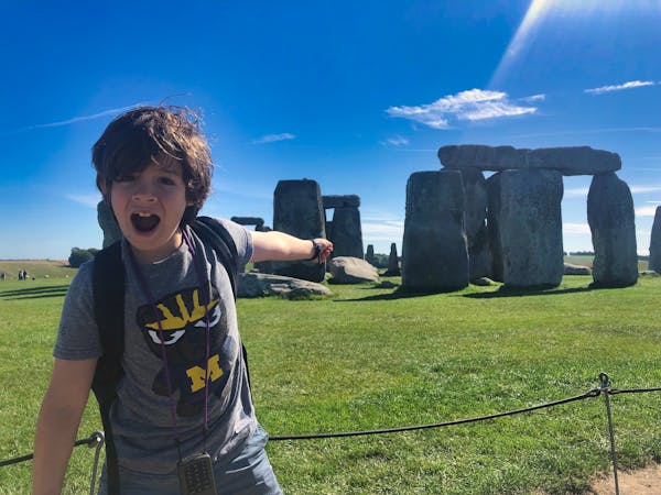 H pretty shocked by Stonehenge behind him