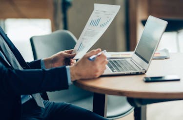 A man wearing a suit examining the pros and cons of indexed universal life insurance