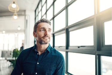 Entrepreneur wearing a tailored blue shirt thinking about his career path using the Cashflow Quadrant