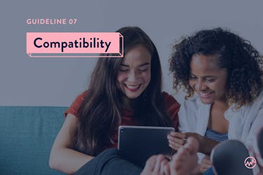 Two female friends looking at compatibility scores on an iPad who plan on buying a house together