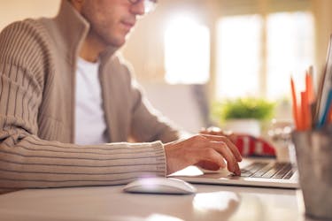 A man writing a goodwill letter to boost his credit score