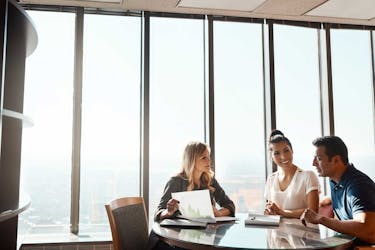 Accountant meeting with a couple discussing their options for paying down student debt