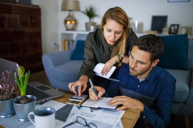 Couple calculating a price for their first house