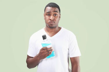 Guy shows mouthwash to maintain oral health