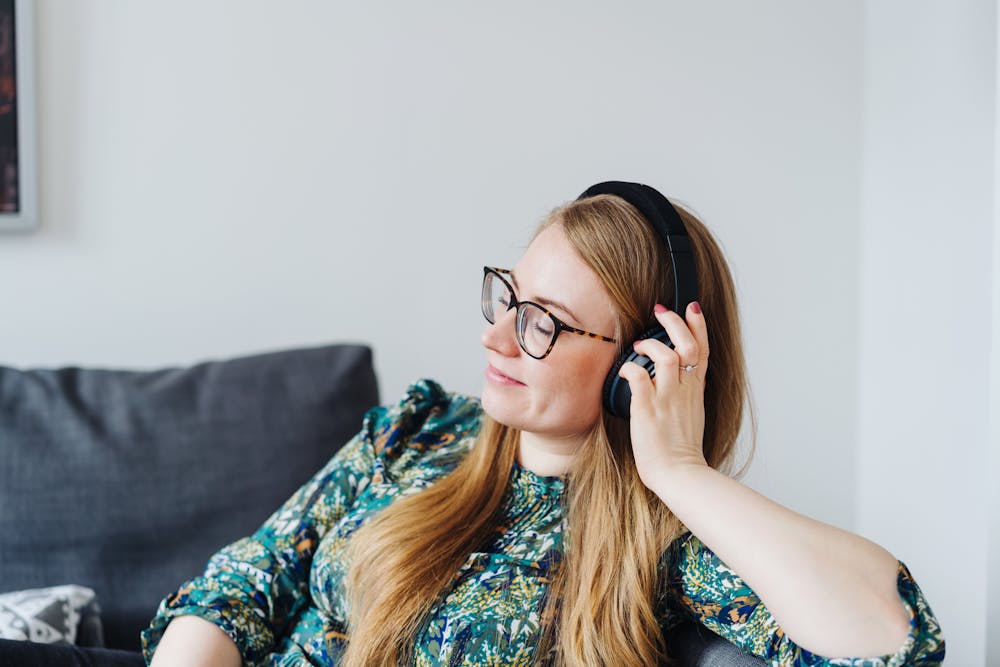 A woman listening to the Get WealthFit Podcast while quarantined at home during the coronavirus