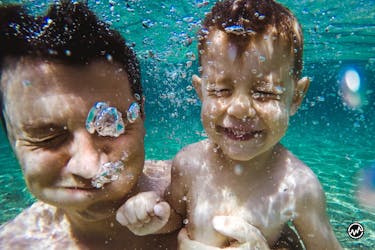 Man and his son swimming on a vacation