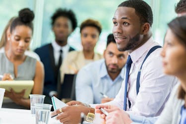 a group of people working on their financial education