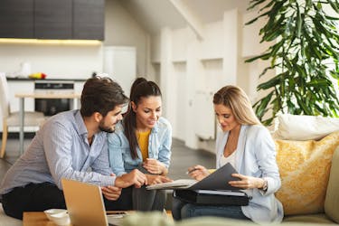 Real estate agent showing various real estate options to the home buyers