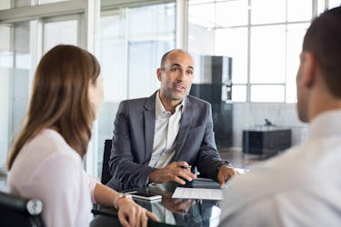 Couple discussing safe investments with financial advisor