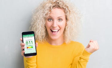 woman shows high credit score on her mobile phone