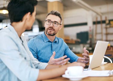 Man practicing leadership skill with coworker.