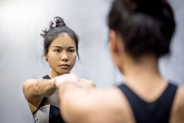 Woman in front of a mirror is saying no to herself