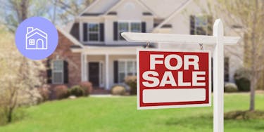 For sale sign in front of a 2 story brick house