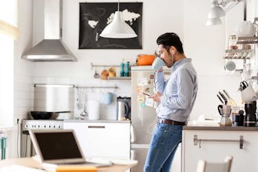 Man multitasking: texting to a friend and talking on the phone at the same time